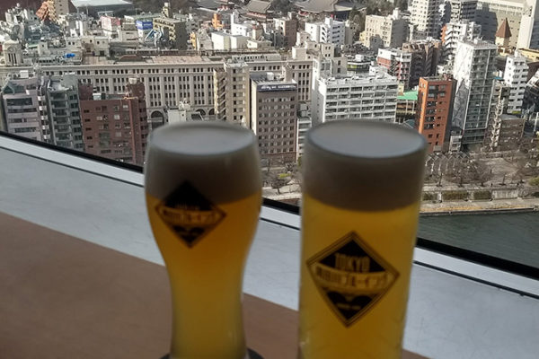 Enjoying an Asahi brew with a view of Tokyo.